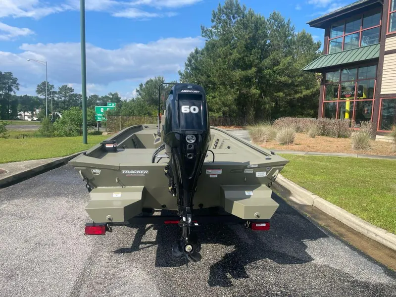 Slide: The Image of 2025 Tracker Grizzly 1860 CC boat with Mercury 60 engine, parked outdoors. - 3