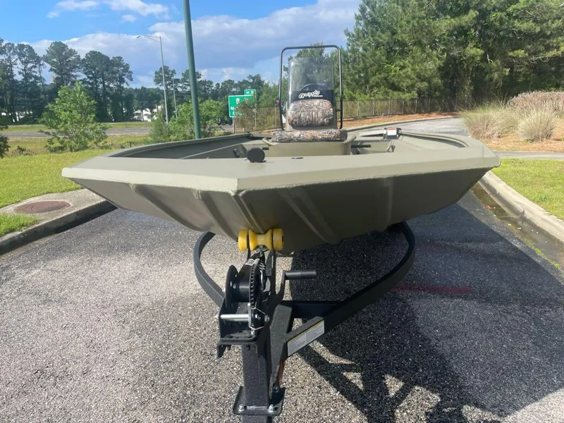 Slide: The Image of 2025 Tracker Grizzly 1860 CC boat on trailer, parked outdoors. - 4