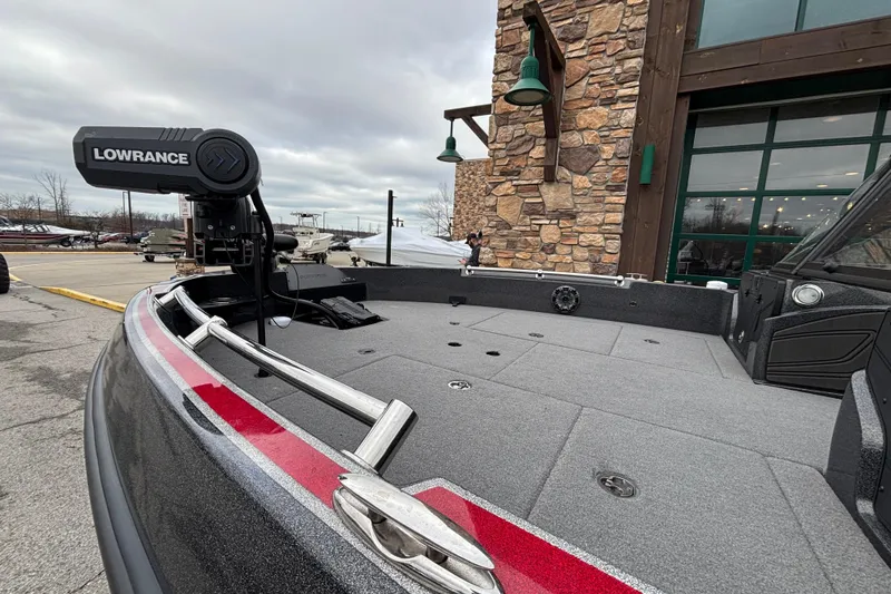 Slide: The Image of 2024 Nitro ZV21 Pro boat with Lowrance equipment, docked near a stone building. - 100