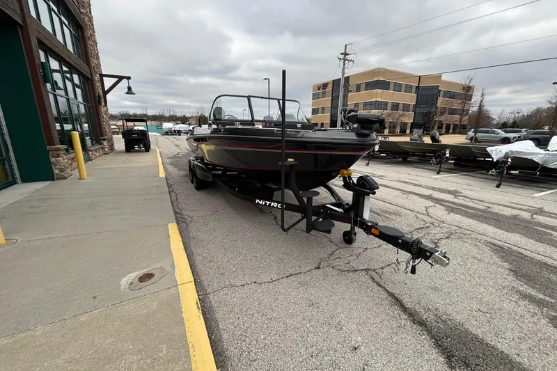 Slide: The Image of 2024 Nitro ZV21 Pro boat on trailer in parking lot, overcast sky. - 102