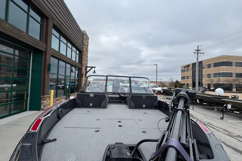 Slide: The Image of 2024 Nitro ZV21 Pro boat displayed outdoors near commercial buildings. - 103