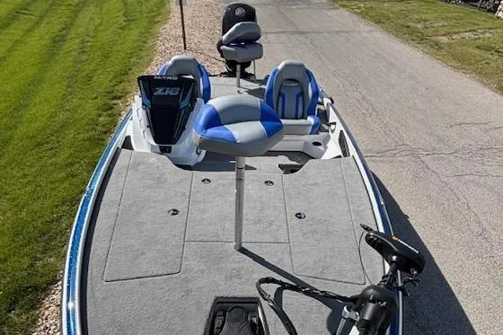 Slide: The Image of 2025 Nitro Z18 Pro fishing boat with Minn Kota trolling motor, parked outdoors. - 2