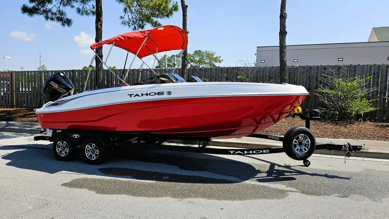 Slide: The Image of 2025 Tahoe T21 boat with red hull and canopy on a trailer. - 3