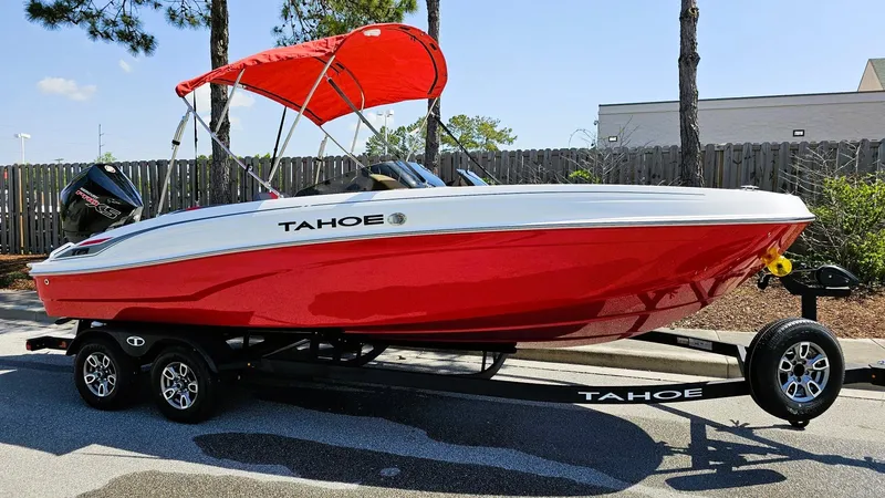Slide: The Image of 2025 Tahoe T21 boat with red hull and canopy on a trailer. - 4