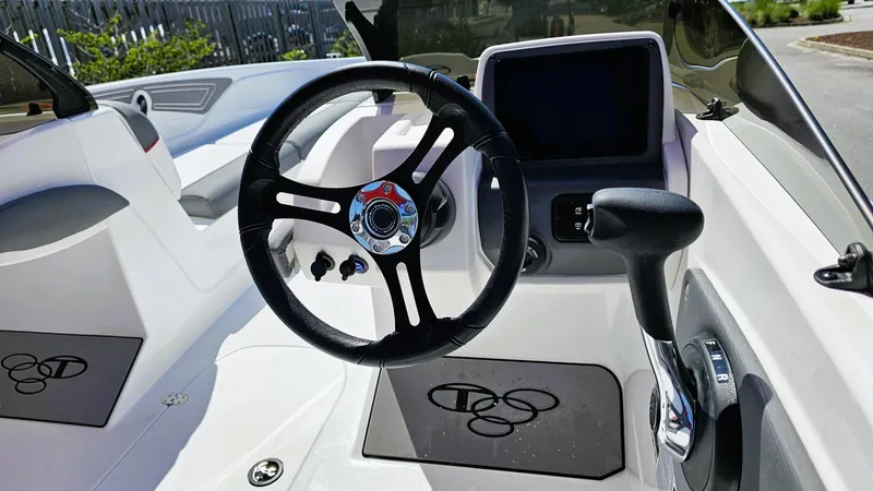 Slide: The Image of Interior of 2025 Tahoe T21 boat featuring steering wheel and control panel. - 8