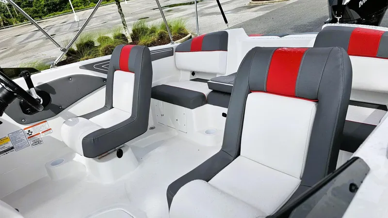 Slide: The Image of 2025 Tahoe T21 boat interior with gray and red cushioned seats. - 10