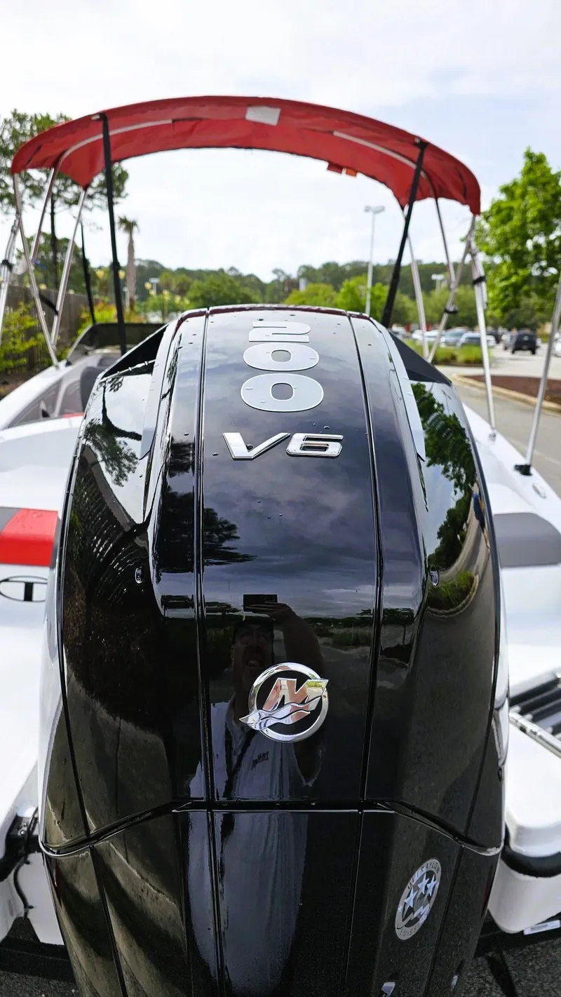 Slide: The Image of 2025 Tahoe T21 boat with V6 engine and red canopy. - 14