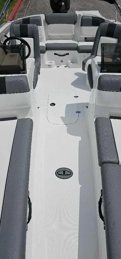 Slide: The Image of 2025 Tahoe T21 boat interior with gray seating and steering console. - 3