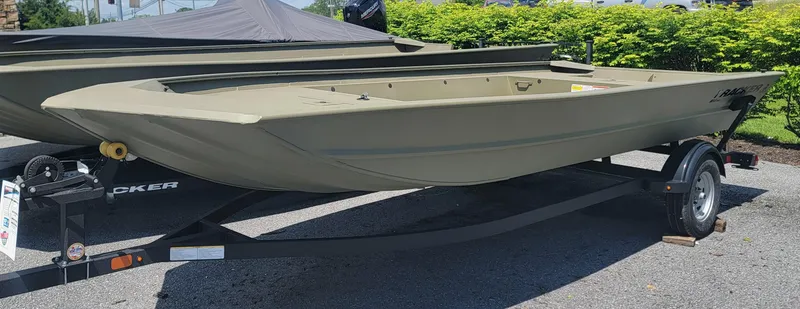 Slide: The Image of 2025 Tracker GRIZZLY 1860 Utility boat on trailer, parked outdoors. - 2