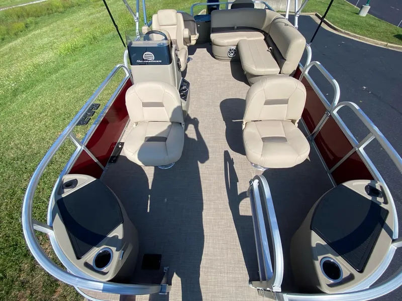 Slide: The Image of 2025 Sun Tracker Bass Buggy 18 DLX pontoon boat interior with seating and console. - 3