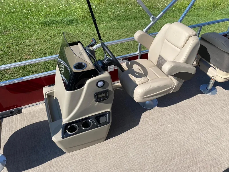 Slide: The Image of 2025 Sun Tracker Bass Buggy 18 DLX boat interior with steering console and comfortable seating. - 5