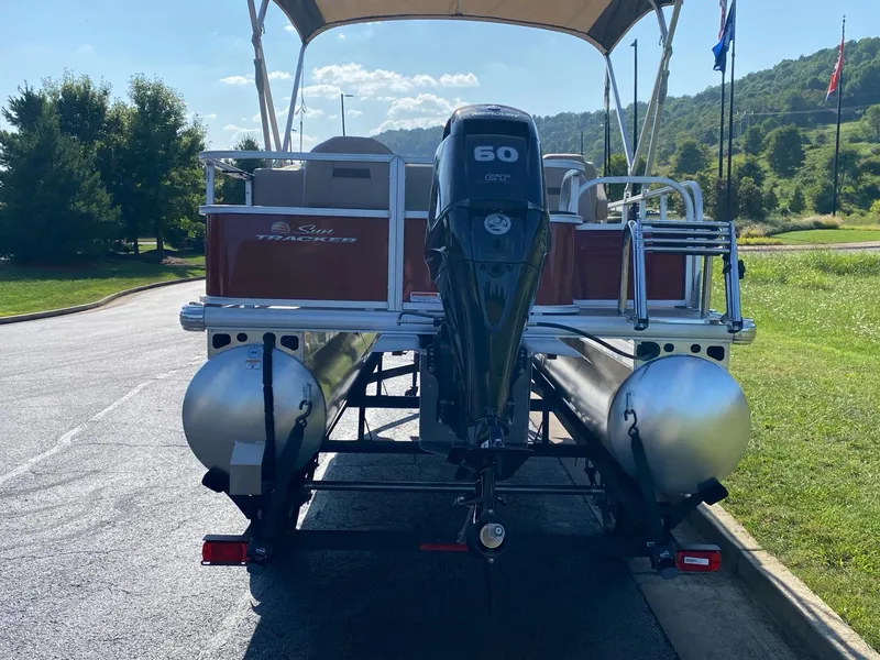 Slide: The Image of 2025 Sun Tracker Bass Buggy 18 DLX pontoon boat with 60 HP engine on trailer. - 7