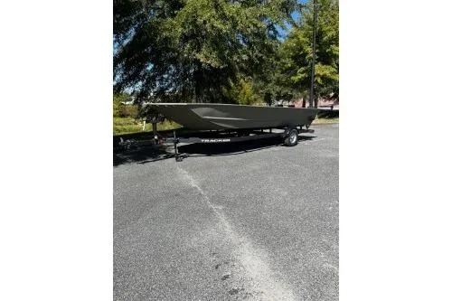 The Image of 2025 Tracker Grizzly 1860 Utility boat on trailer, parked outdoors. - 0
