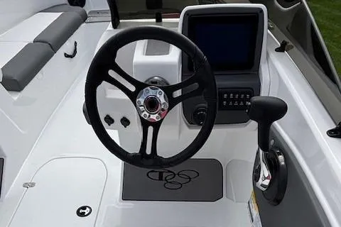 Slide: The Image of 2025 Tahoe T21 boat interior with dual seating, steering console, and modern design. - 2