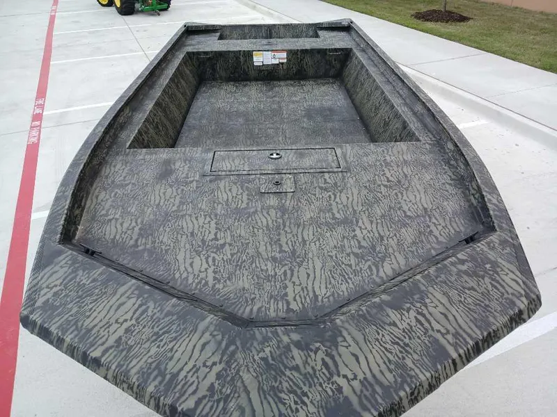Slide: The Image of 2025 Tracker GRIZZLY 1860 Utility boat with camouflage design on concrete surface. - 4
