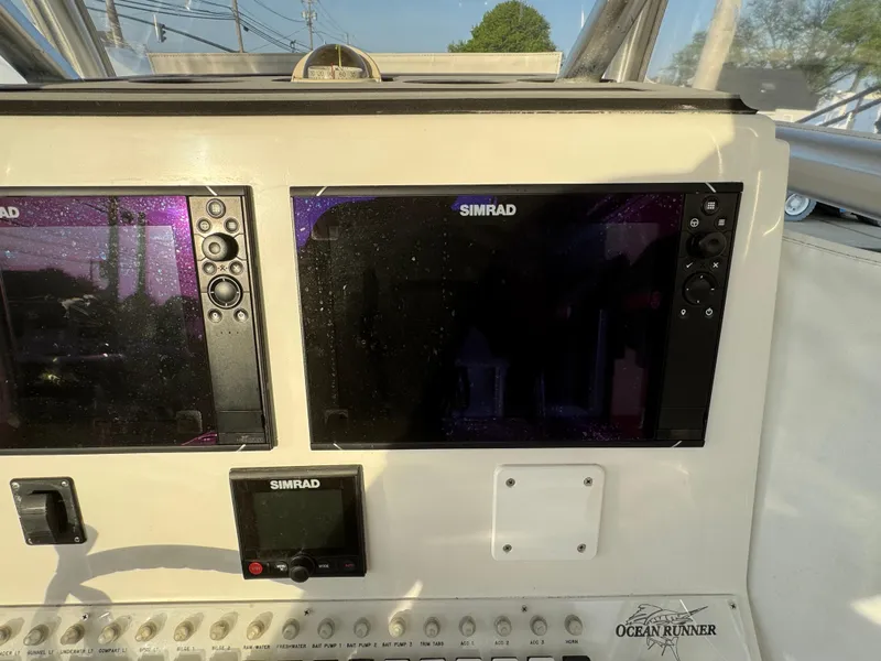 Slide: The Image of Control panel of a 2015 Ocean Runner 2900 boat with Simrad displays. - 6