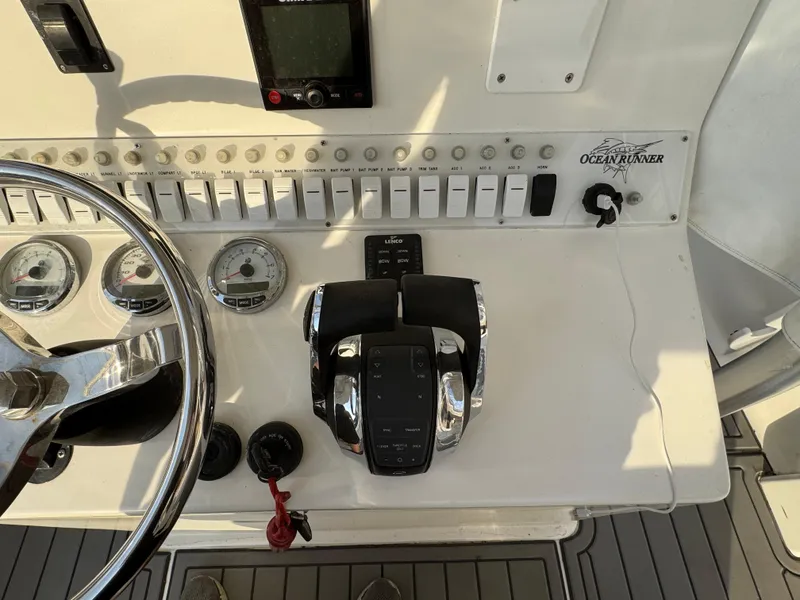 Slide: The Image of Control panel of a 2015 Ocean Runner 2900 boat with steering wheel and throttle. - 7