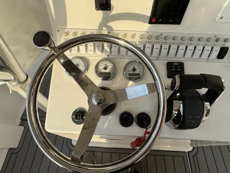 Slide: The Image of Steering wheel and controls of a 2015 Ocean Runner 2900 boat. - 8