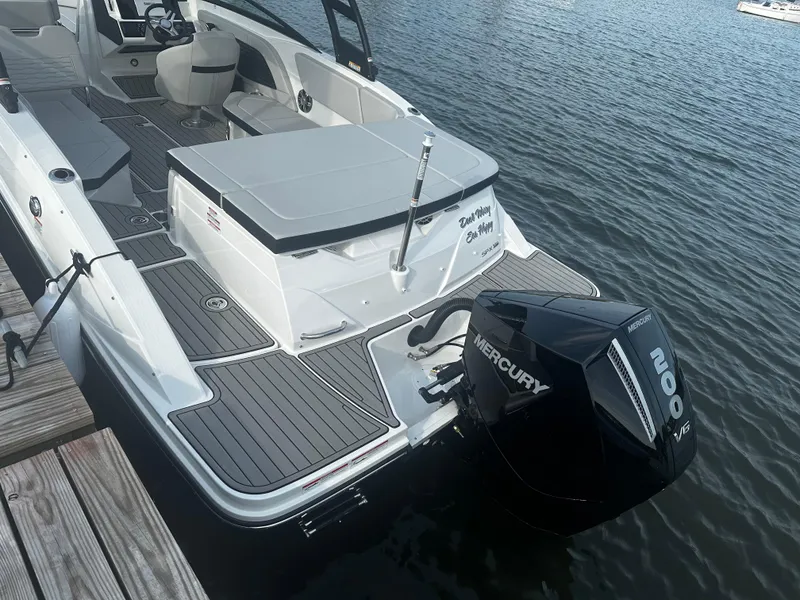 Slide: The Image of 2024 Sea Ray 230SPX boat with Mercury engine docked on calm water. - 3