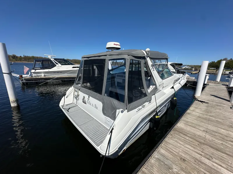 Slide: The Image of 1990 Sea Ray 310 Sundancer docked at marina under clear blue sky. - 11