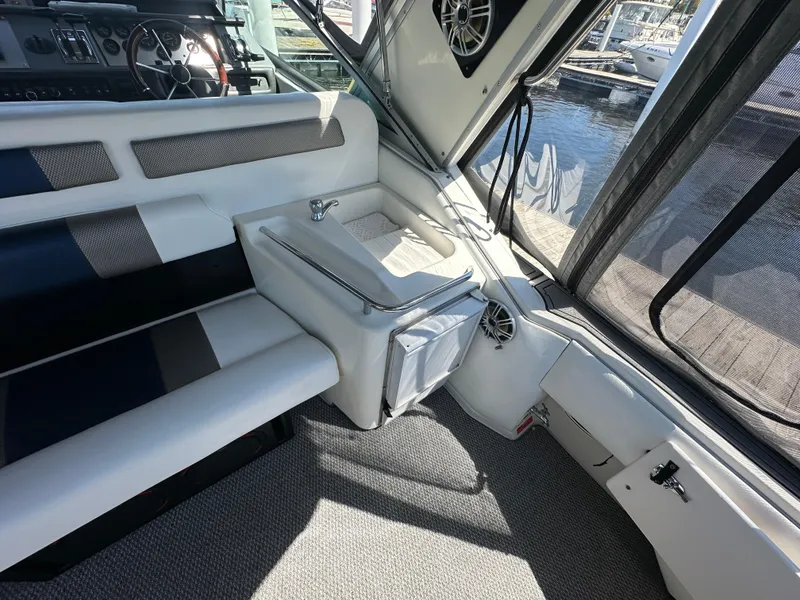 Slide: The Image of Interior of 1990 Sea Ray 310 Sundancer boat with seating and sink. - 18