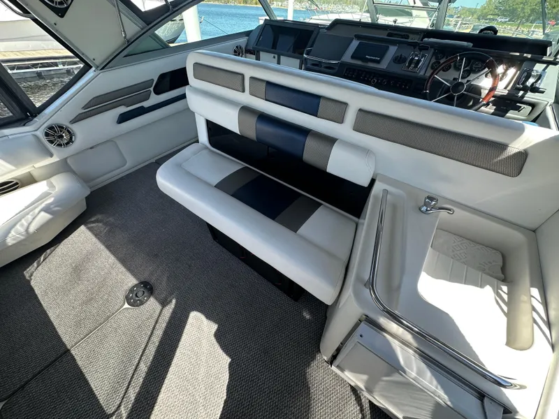 Slide: The Image of 1990 Sea Ray 310 Sundancer interior with helm and seating area. - 19