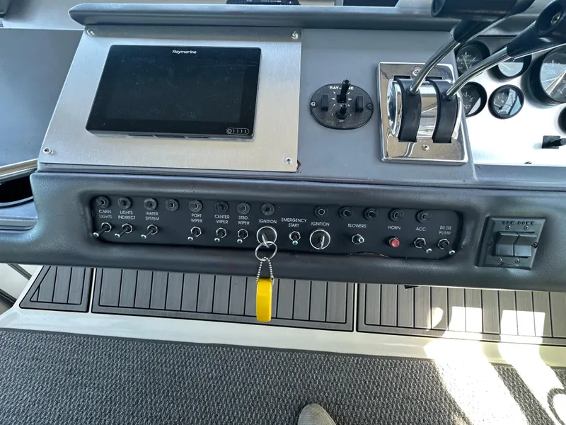 Slide: The Image of Control panel of a 1990 Sea Ray 310 Sundancer boat with switches and gauges. - 24