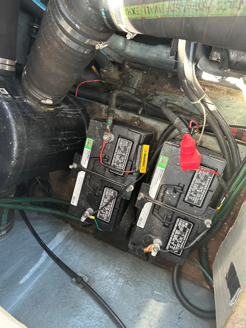 Slide: The Image of Engine compartment of 1990 Sea Ray 310 Sundancer with dual batteries and wiring. - 29