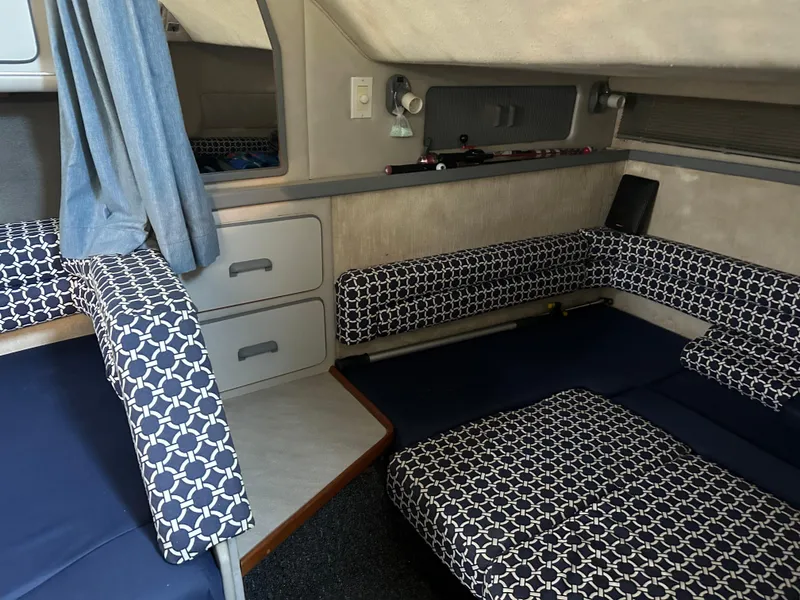 Slide: The Image of Interior of 1990 Sea Ray 310 Sundancer with patterned seating and storage drawers. - 39