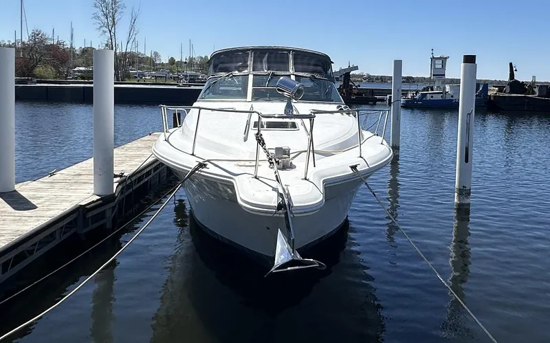 Slide: The Image of 1990 Sea Ray 310 Sundancer docked at marina, front view. - 5