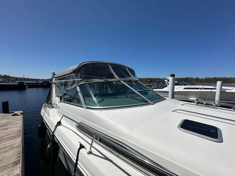 Slide: The Image of 1990 Sea Ray 310 Sundancer docked at marina under clear blue sky. - 7