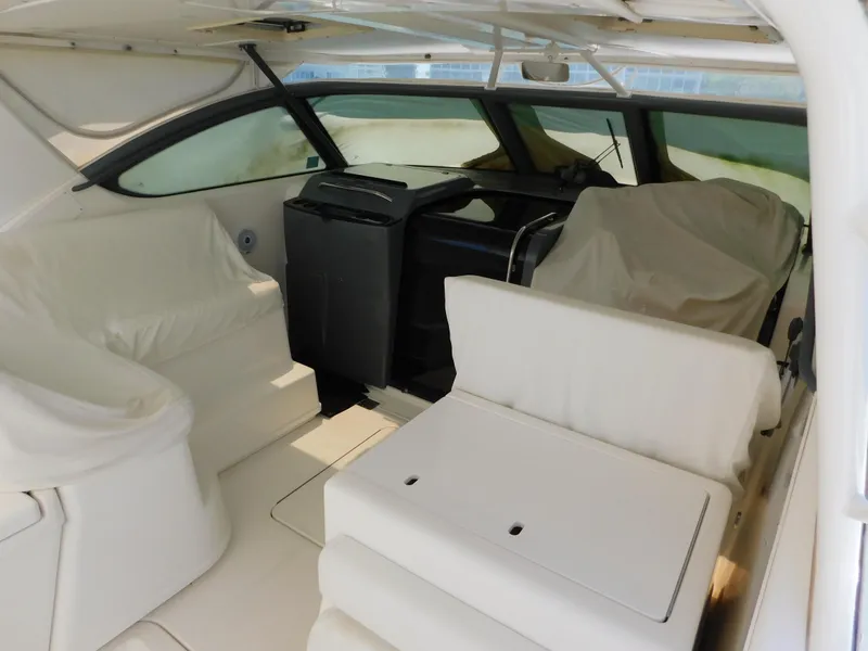 Slide: The Image of 2001 Tiara Yachts 3800 Open interior with covered seating and helm. - 10