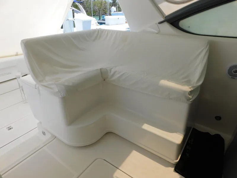 Slide: The Image of 2001 Tiara Yachts 3800 Open interior seating with white cover. - 12