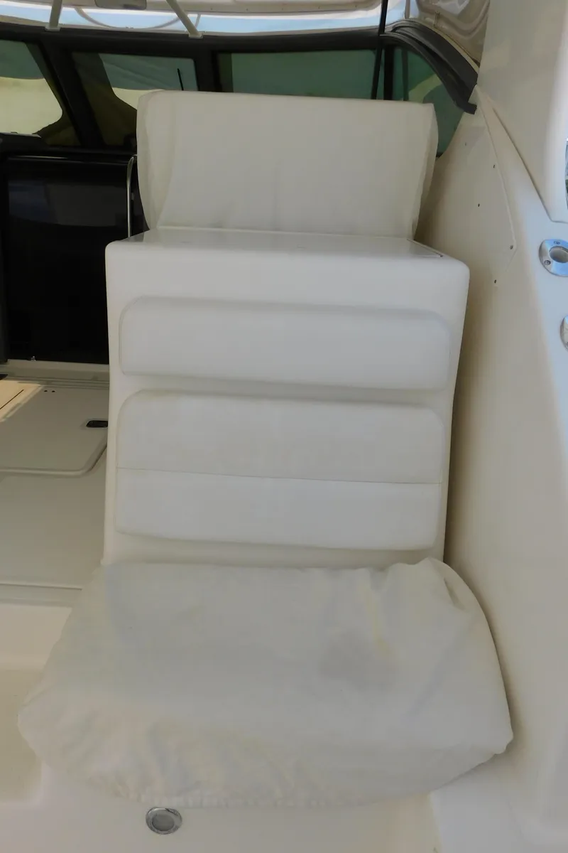 Slide: The Image of 2001 Tiara Yachts 3800 Open, white cushioned seating detail. - 19