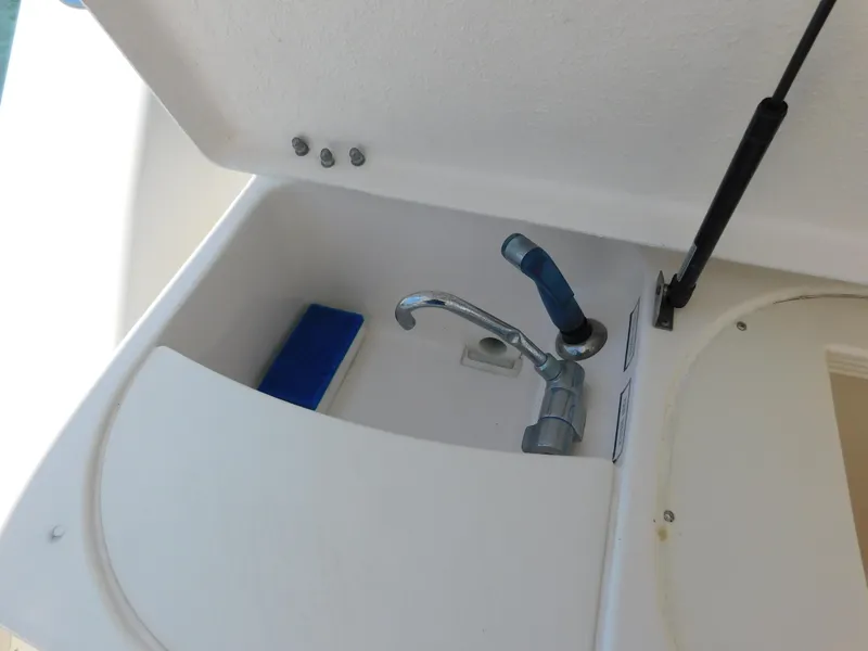 Slide: The Image of Tiara Yachts 3800 Open 2001 sink with faucet and storage compartment. - 21
