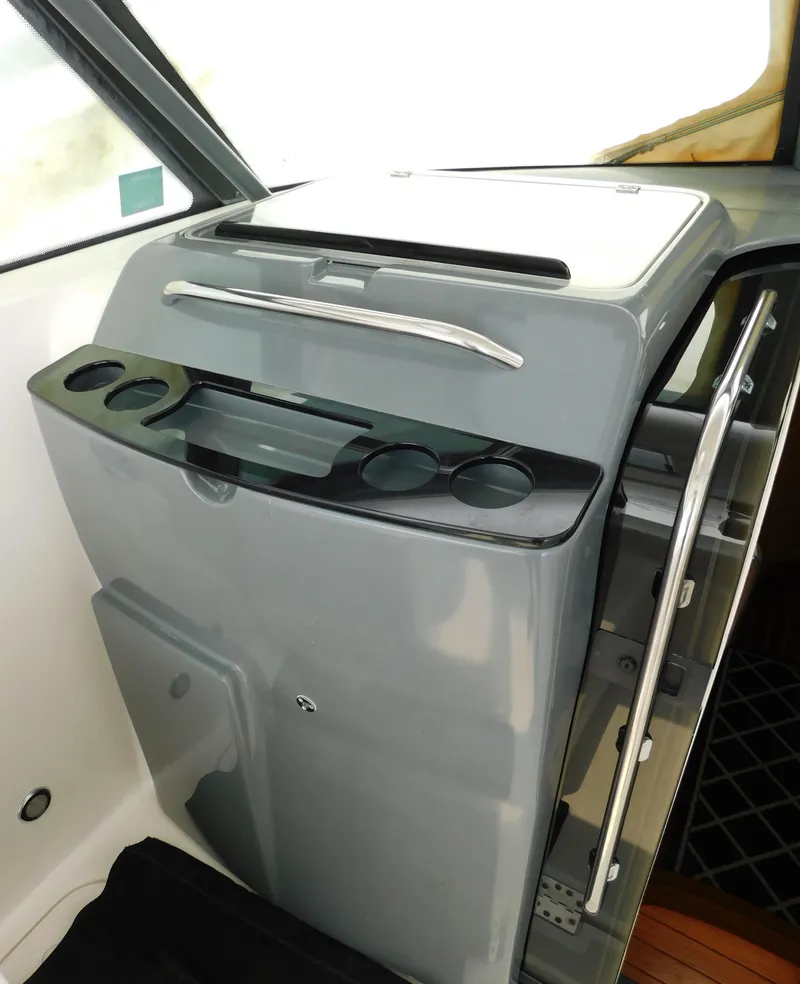 Slide: The Image of 2001 Tiara Yachts 3800 Open interior with cup holders and storage compartment. - 27
