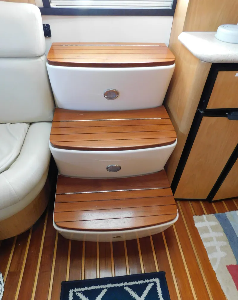 Slide: The Image of Wooden steps inside a 2001 Tiara Yachts 3800 Open, featuring elegant design and craftsmanship. - 30