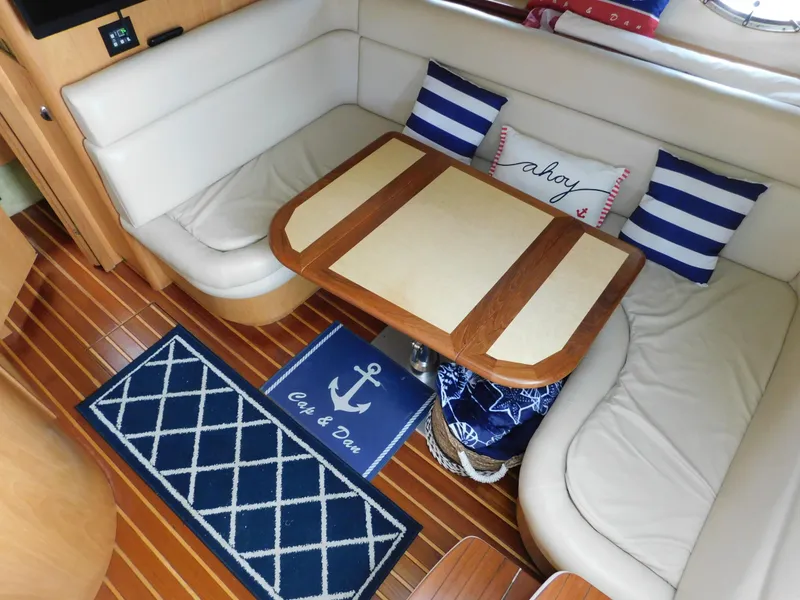 Slide: The Image of 2001 Tiara Yachts 3800 Open interior with cozy seating and nautical decor. - 31
