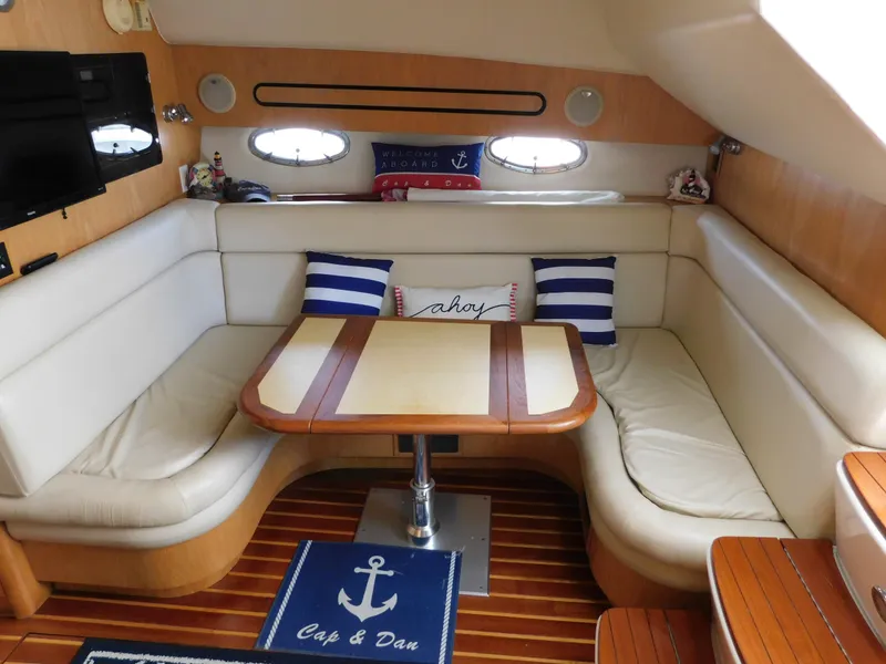 Slide: The Image of Interior of 2001 Tiara Yachts 3800 Open with cozy seating and nautical decor. - 32