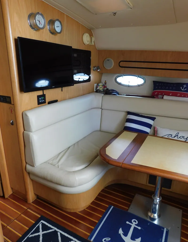 Slide: The Image of Interior of 2001 Tiara Yachts 3800 Open with cozy seating and nautical decor. - 33