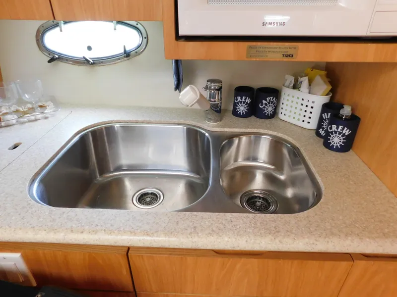 Slide: The Image of 2001 Tiara Yachts 3800 Open kitchen sink with dual basins and countertop accessories. - 39