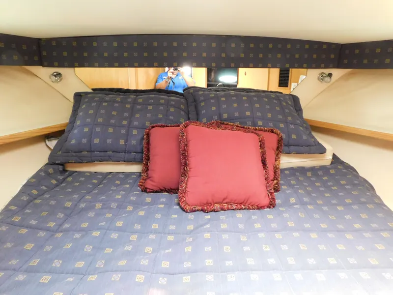Slide: The Image of Cozy cabin bed in 2001 Tiara Yachts 3800 Open with decorative pillows. - 44