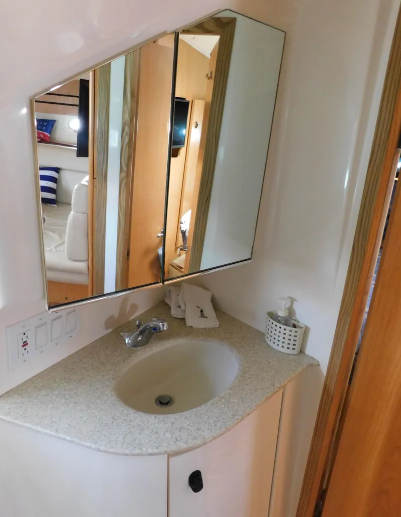 Slide: The Image of 2001 Tiara Yachts 3800 Open bathroom with sink, mirror, and soap dispenser. - 47