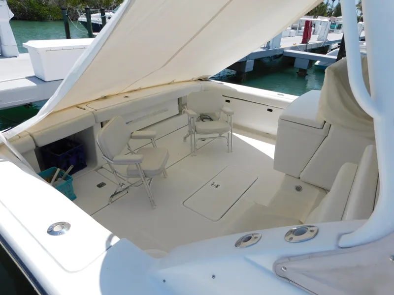 Slide: The Image of 2001 Tiara Yachts 3800 Open cockpit with seating and canopy, docked at marina. - 5
