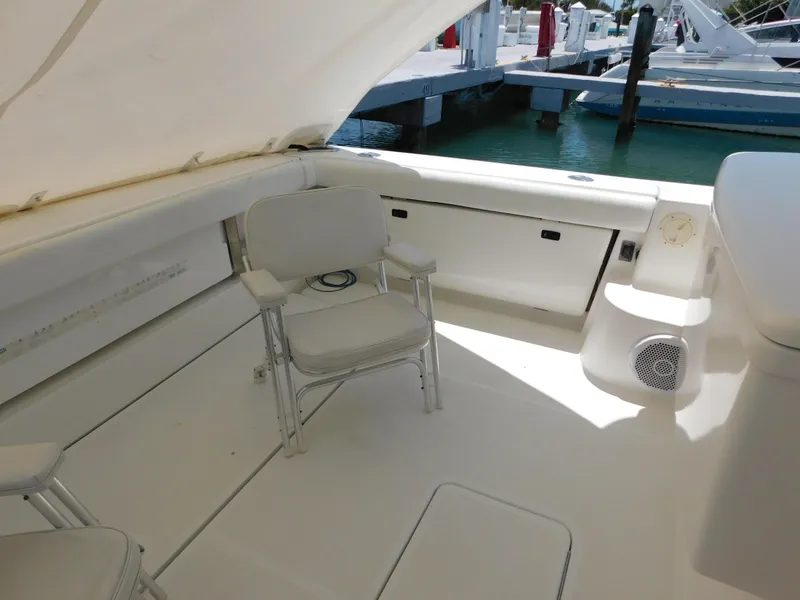 Slide: The Image of 2001 Tiara Yachts 3800 Open cockpit with seating, docked at marina. - 7