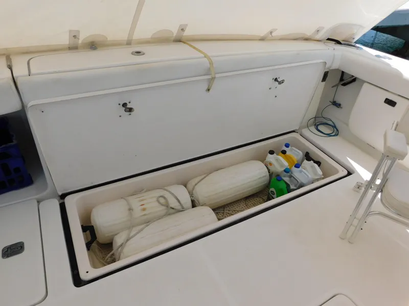 Slide: The Image of Storage compartment on a 2001 Tiara Yachts 3800 Open, containing fenders and cleaning supplies. - 9
