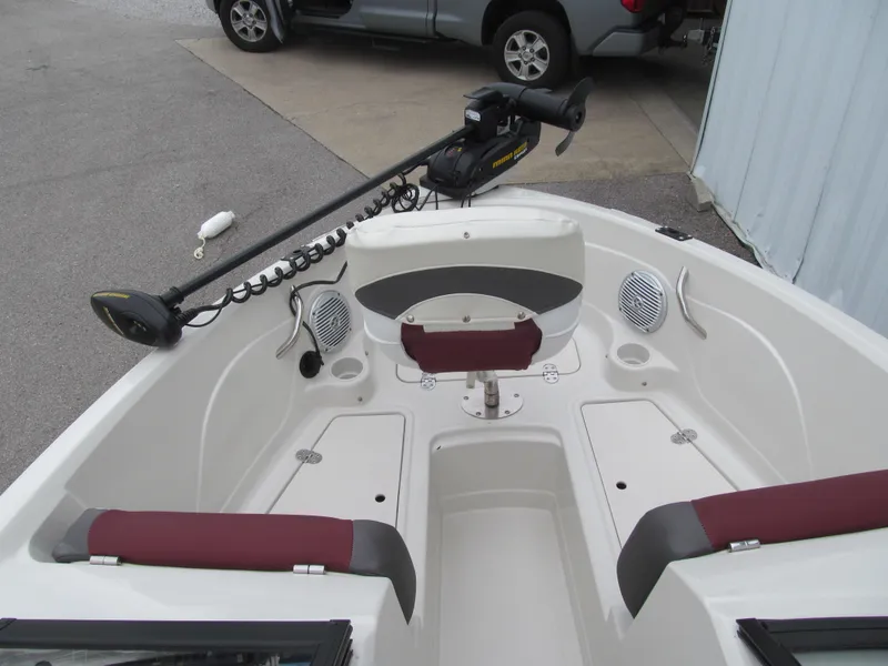 Slide: The Image of 2016 Tahoe 550 TF boat interior with maroon seating and trolling motor. - 12