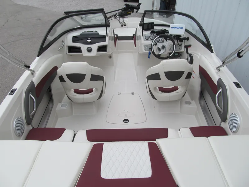 Slide: The Image of 2016 Tahoe 550 TF boat interior with red and white seating, steering wheel, and dashboard. - 4