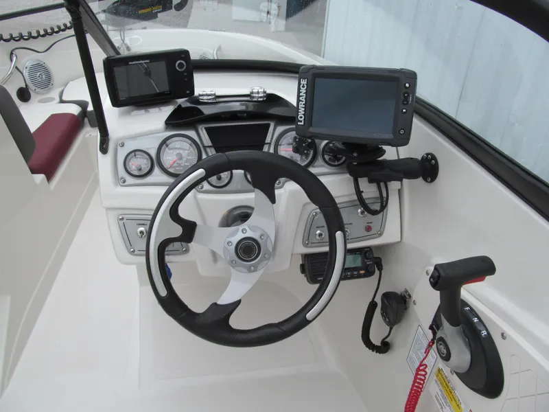 Slide: The Image of 2016 Tahoe 550 TF boat dashboard with steering wheel and navigation equipment. - 5