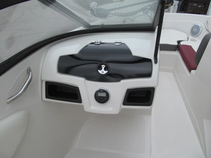 Slide: The Image of 2016 Tahoe 550 TF boat dashboard with steering wheel and seating area. - 6